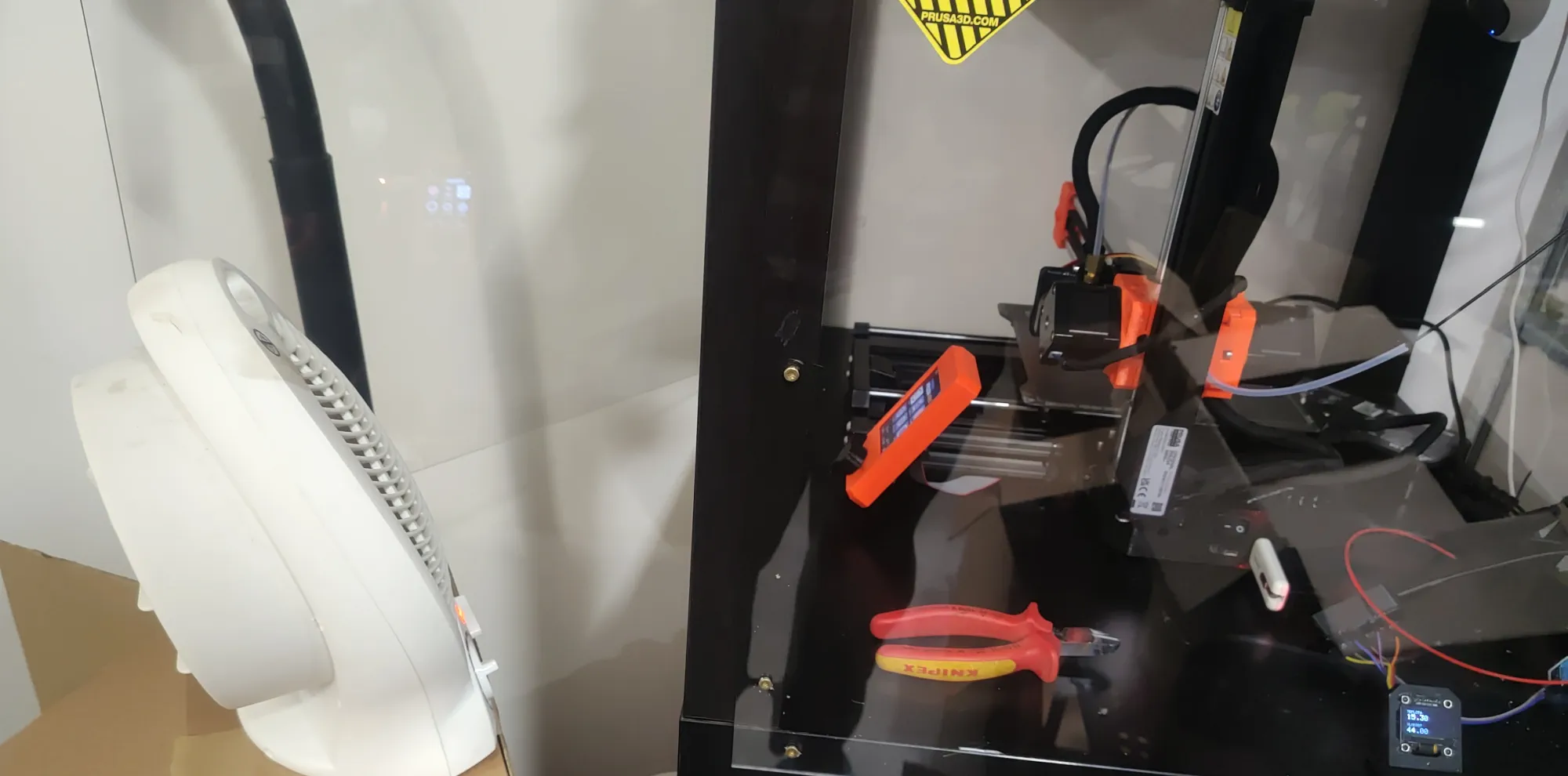 Prusa Mini in the garage with a heater pointing at it